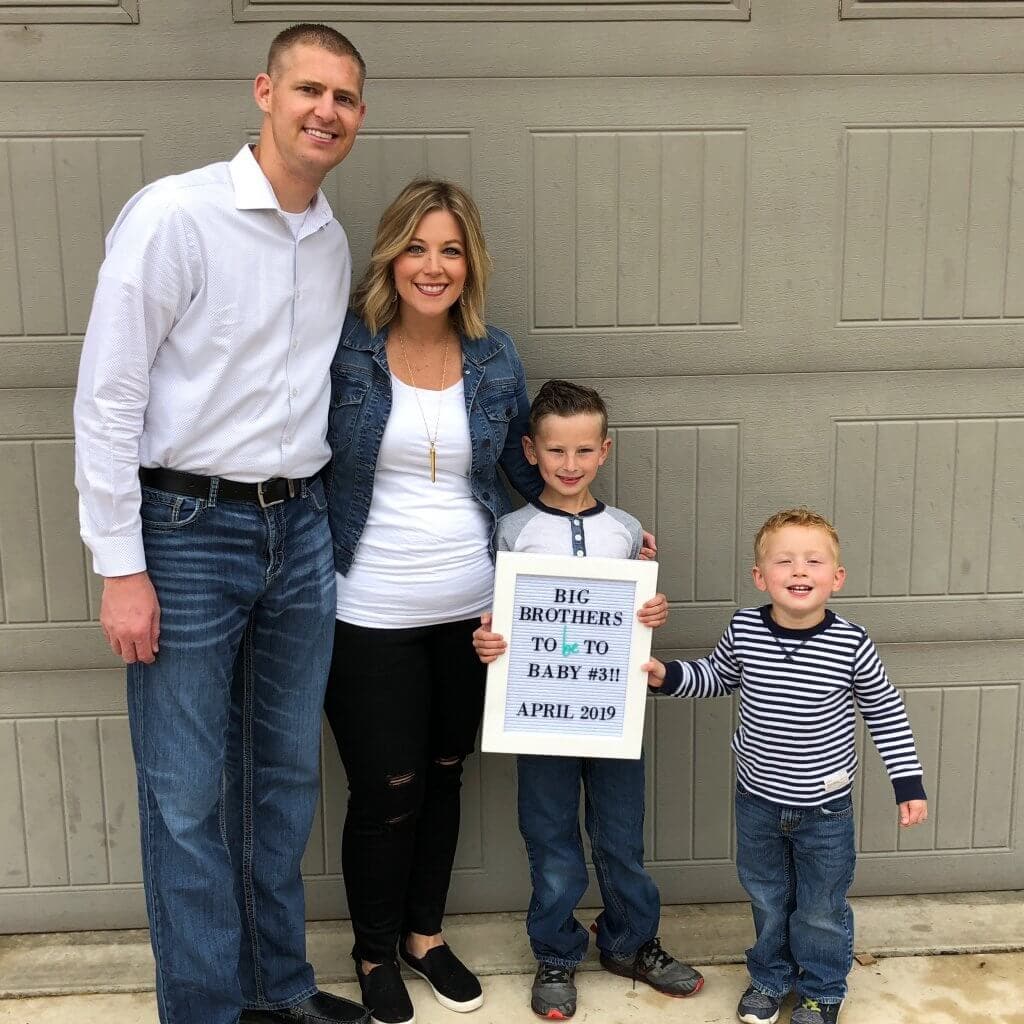 A family of four announcing they are having a baby.