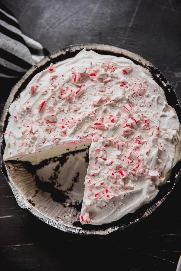 Overhead photo of a White Chocolate Peppermint Oreo Pie with one slice missing
