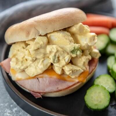 A delicious recipe that can be eaten for any meal! The Air Fryer Ham, Cheese & Egg Salad Bagel Sandwich is so simple and satisfying! #airfryer #hamandcheese #airfryerbagel