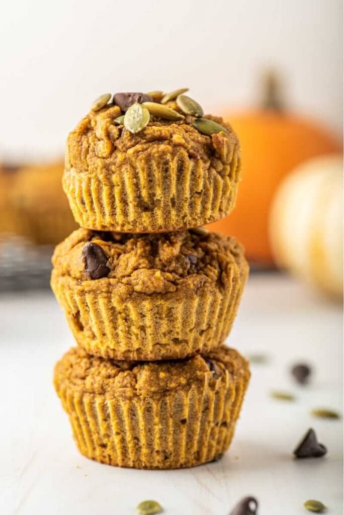 Three healthy pumpkin muffins stacked on top of each other