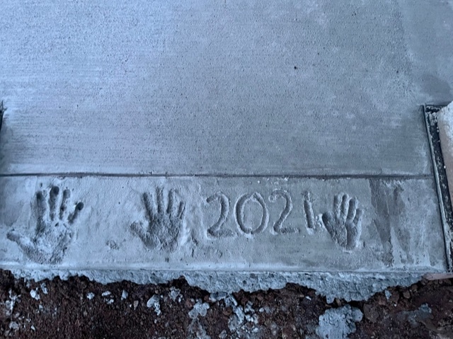 Children's handprints placed in concrete 