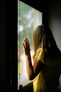 woman looking outside of a window